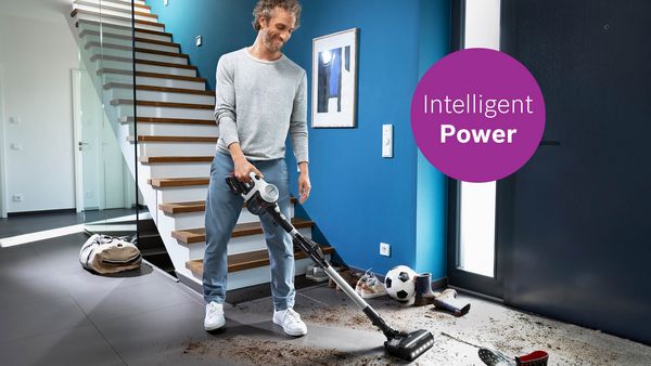 Man cleaning very dirty floor with unlimited 7 vacuum cleaner