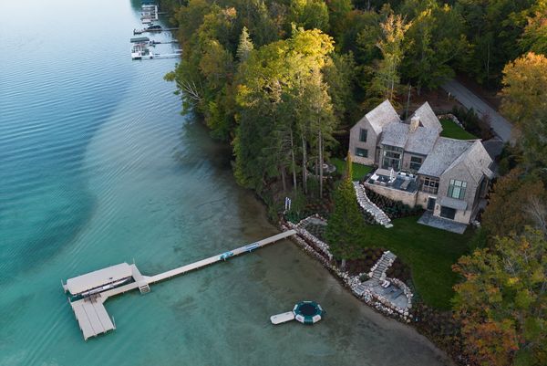 Aerial view of the lake house during the early evening