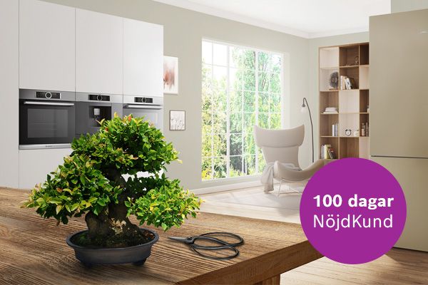 Bonsaitr&auml; och svarta saxar p&aring; ett tr&auml;bord i ett stilfullt Bosch-k&ouml;k med &ouml;ppen planl&ouml;sning.