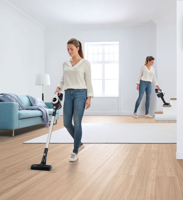 Woman cleaning house with Unlimited 6 vacuum cleaner