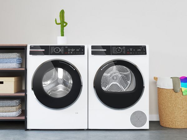 Bosch Serie 8 wasmachine met i-DOS staat naast een droger. Er staat een kleine cactus op met zijn duim omhoog.