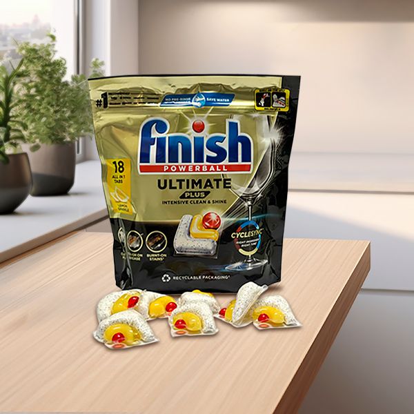 A package of Finish dishwasher tablets on the countertop of a modern kitchen.