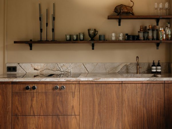 Image of the kitchen where the materials use an elemental palette, just wood, steel and real stone. 