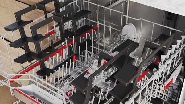 Un lave-vaisselle ouvert contient plusieurs supports de casseroles.