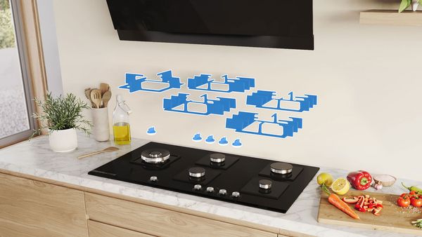 Les éléments amovibles sont suspendus au-dessus de la plaque de cuisson au gaz Bosch et brillent d'un éclat bleu.