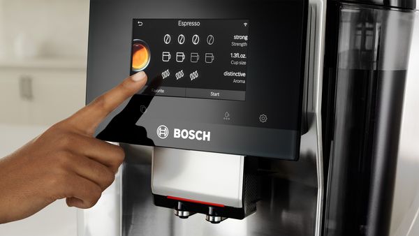 Hand selecting coffee style on Series 8 VeroCafe machine touch display.