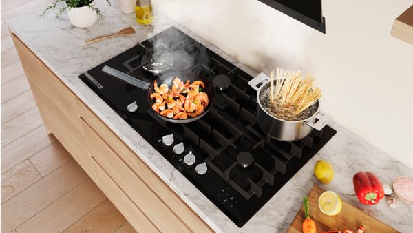 Bosch gas hob with a pot of stew on it,  in a sleek modern kitchen representing one  of many gas hobs to choose from.