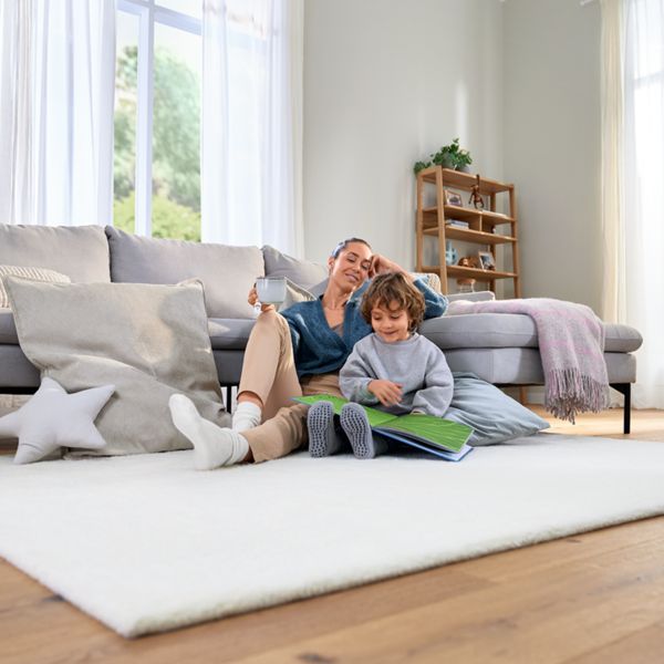 Woman and child sat on living room floor