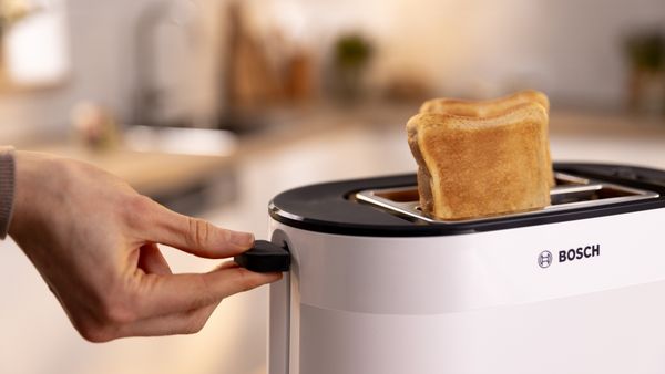 Person lifting toast out of Bosch toaster