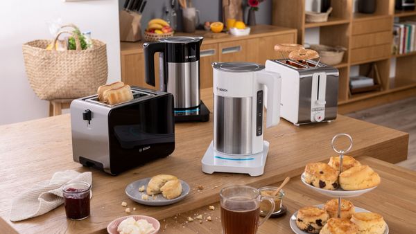 Multiple Bosch kettles and toasters surrounded by food and drink