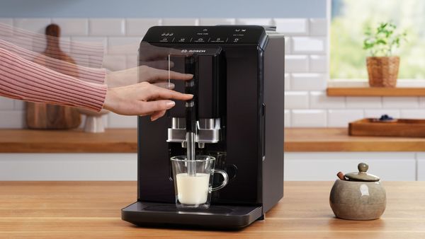 Person using Bosch coffee machine