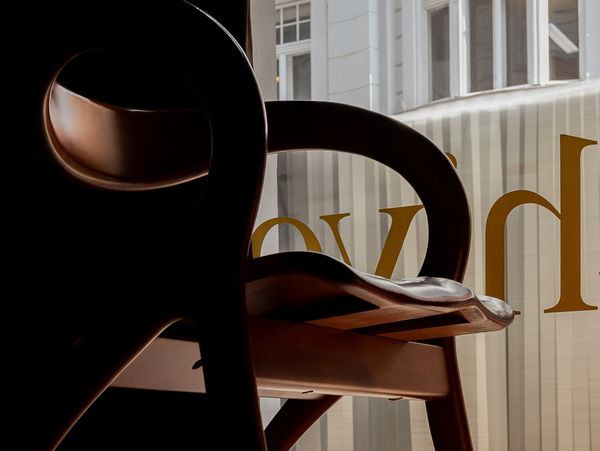 The silhouette of a chair against the front window of Atelier Karasinski Archive