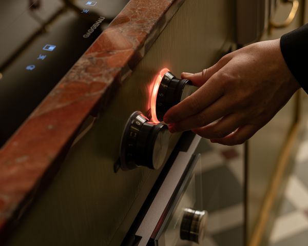 Laura Karasinski using the Gaggenau Induction hob control knob  