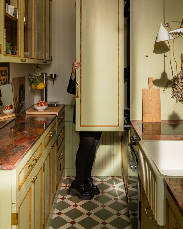 Galley style kitchen with a Gaggenau Vario cooling Expressive series appliance with custom green and gold door furniture in Atelier Karasinski Archive 
