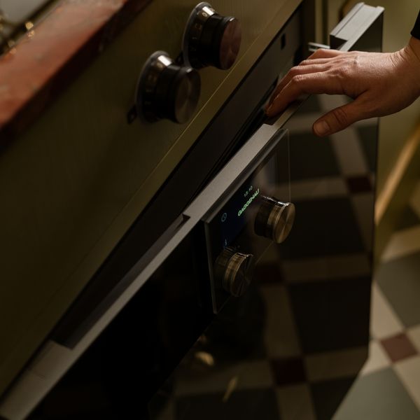 Laura Karasinski opening the Gaggenau convection oven in Atelier Karasinski Archive  