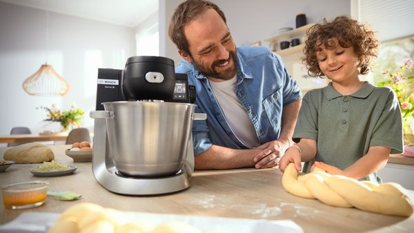 Family using Bosch mixer to make dough