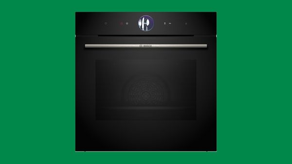 Schwarzer Backofen auf grünem Hintergrund.