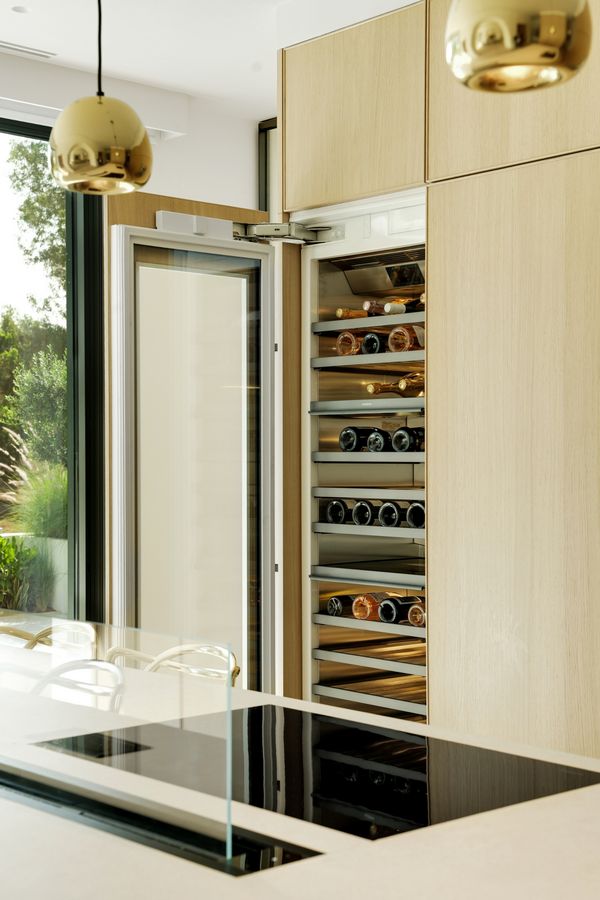 View across the kitchen island fitted with a Gaggenau flex induction cooktop, 200 series table ventilation and 400 series wine climate cabinet
