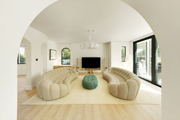 Wide angle view through an arch into the lounge area of the villa
