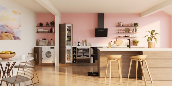 A kitchen featuring a sink, a dining table, and a refrigerator, showcasing a functional and inviting space.  