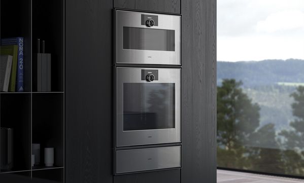 View into an open plan luxury kitchen fitted with Gaggenau Expressive series appliances.