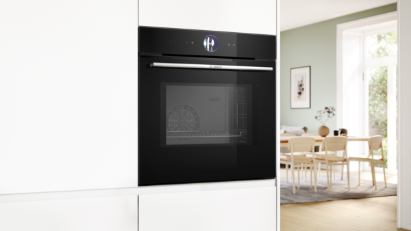 A black built-in oven with a digital control ring and TFT touch display.