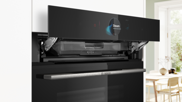 A black Bosch Serie 8 built-in oven with an open door revealing the interior and digital control ring.