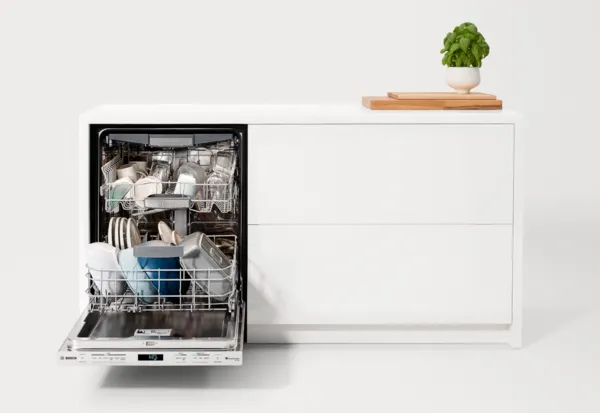 bosch dishwasher open in a white room & cabinet