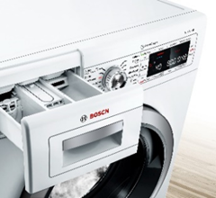 A close-up view of a white Bosch front-loading washing machine with its detergent dispenser drawer pulled open