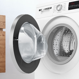 A front-loading washing machine with its door open, revealing the empty drum.