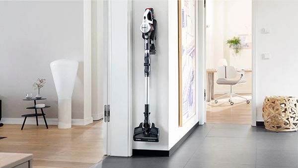 A selection of cordless vacuum cleaners in a living room.