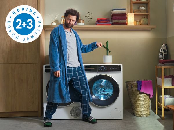 Ugodna praonica s modernom perilicom, uredno složenim ručnicima i policom s dekorativnim predmetima, što povećava toplinu prostora