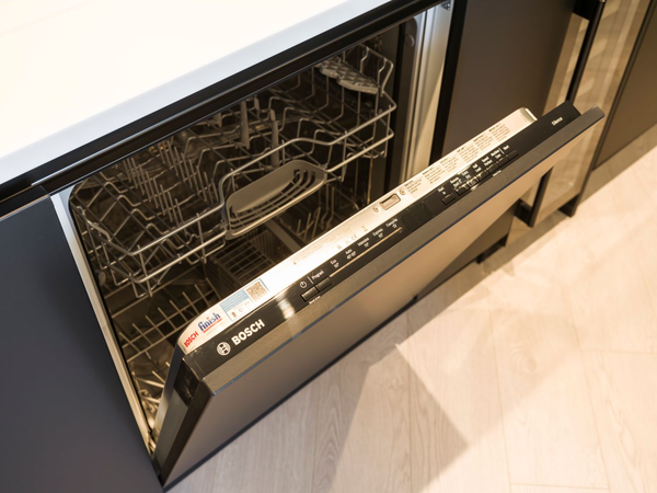 Bosch dishwasher with door partially open showing interior