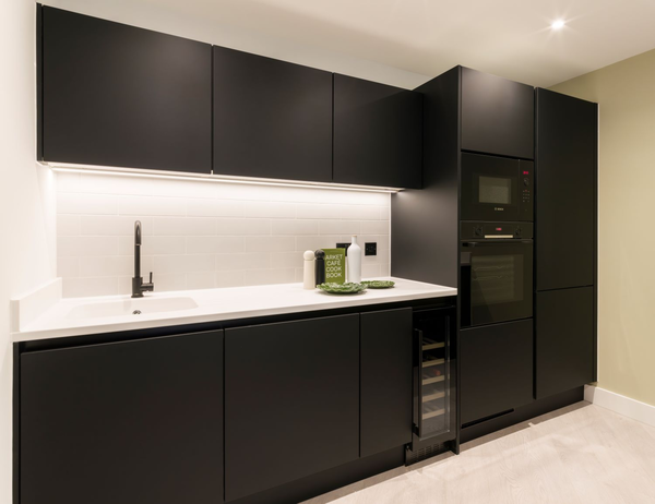 Black and white clean lit kitchen back wall area