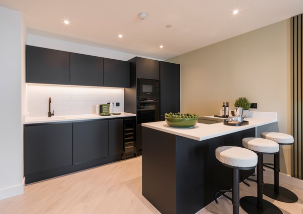 Black and white clean lit kitchen entire island area