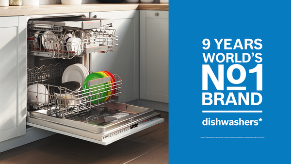 Bosch dishwasher with door down and inside drawers filled with dishes partially pulled out
