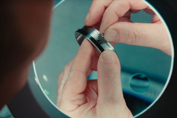 Under a magnifying glass an engineer fits components to the floating control ring