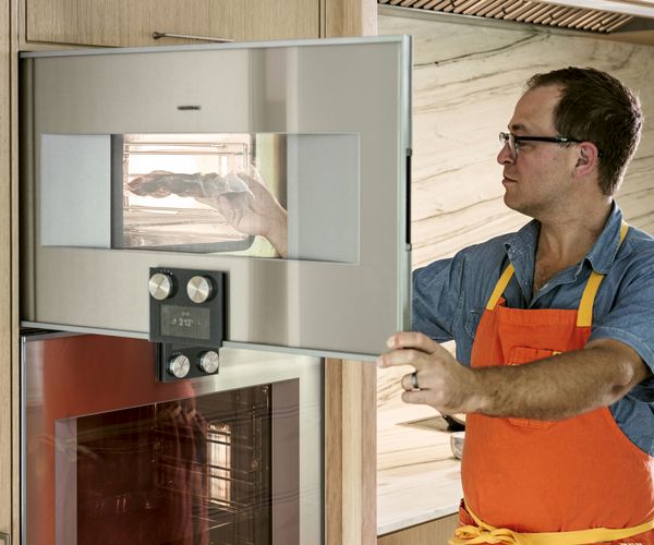 Sam Fertik using his Gaggenau combi-steam oven.