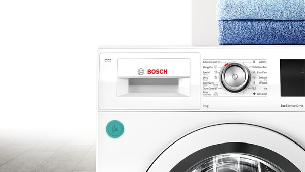 A close-up view of the control panel and upper portion of a white Bosch Serie 8 front-load washing machine, model WAW32541.
