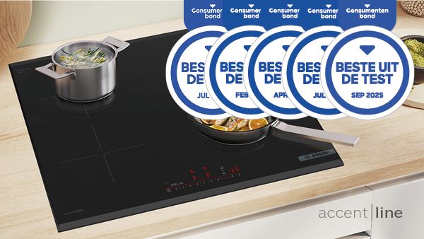 Moderne inductiekookplaat met een koekenpan met vis en een pan met groenten, bekroond met prijzen voor de beste prestaties.