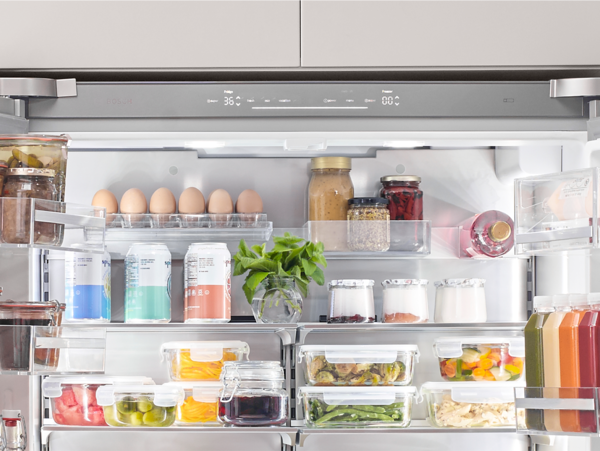 Bosch refrigerator open with produce drinks and jars