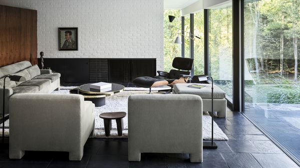 Lounge area for entertaining guests which opens up into the garden via floor to ceiling glass panels