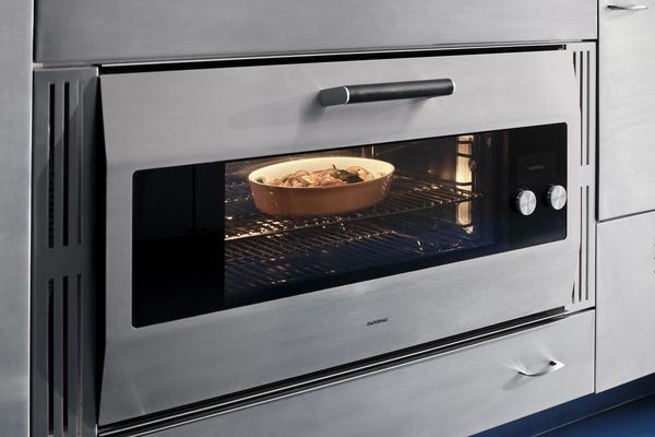 The Gaggenau EB333 oven blending in with the St. Charles steel kitchen cabinetry