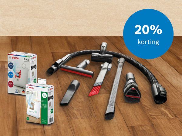 Op de vloer liggen stofzuigeraccessoires en stofzakken, ook een rondje met tekst 20% korting