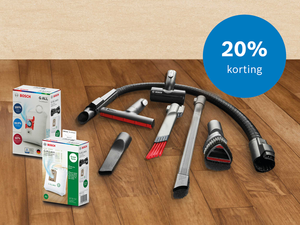 Op de vloer liggen stofzuigeraccessoires en stofzakken, ook een rondje met tekst 20% korting.