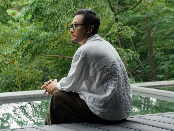 Portrait of Wu Bin as he sits outside admiring the view