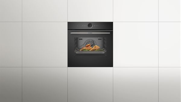 Модерна кухня с вградена фурна, минималистична маса и чисти бели стени.