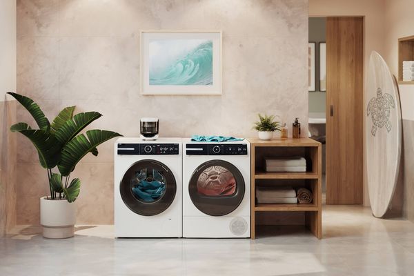 Microplastic filter on top of washing machine next to tumble dryer in open room