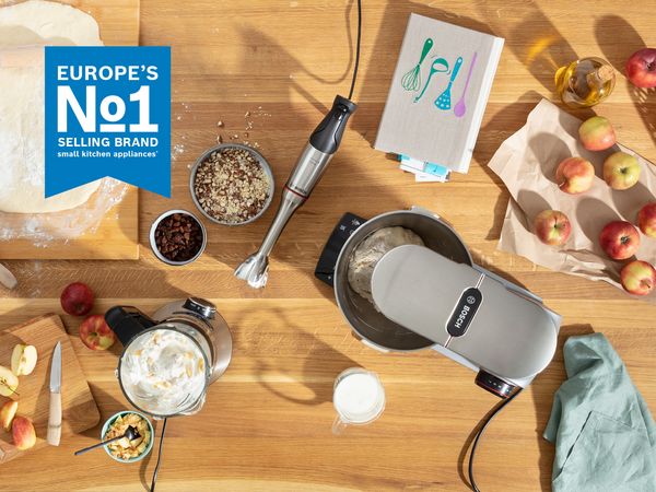 Bosch hand mixer in a stylish kitchen setting with food preparation items visible. 