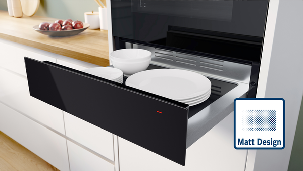 Bosch W&auml;rmeschublade  in Schwarz Matt, ge&ouml;ffnet unter dem Backofen in moderner K&uuml;che